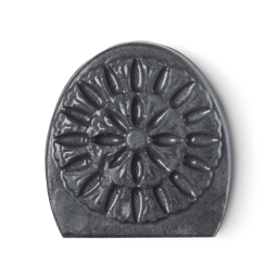 Charcoal. A dark grey, slightly shimmery, semi-oval shaped facial soap with an intricate engraving design.