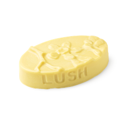 Each Peach (And Two's A Pair). A buttery yellow, oval shaped, solid massage bar, with an embossed orange fruit flower design.