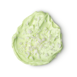 A swatch of bright, light, lime green coloured Lime Bounty body butter, topped with a sprinkling of what looks like coconut.