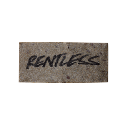 A grey, rectangular washcard, consisting of apple pulp, with 'Rentless' written across it in black Lush writing.