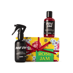 Rose Jam. A rectangular box, wrapped in yellow, red rose printed Khadi paper, tied with a deep red ribbon and a green gift tag.