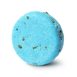 Seanik. A bright blue, circular solid shampoo bar, with tiny pieces of green seaweed pressed within.